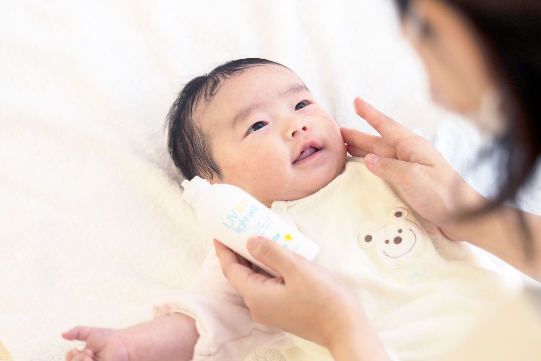 日焼け止めを塗るお母さんと赤ちゃん